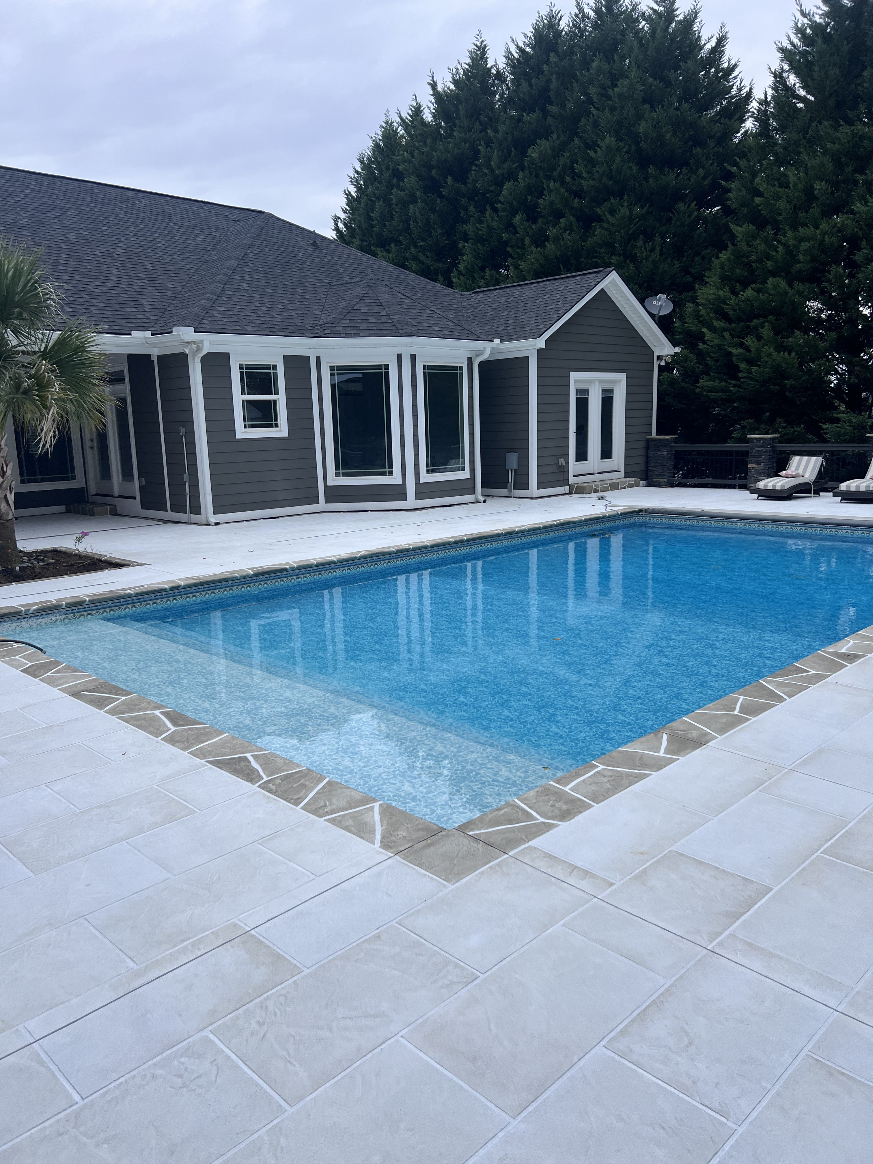 Stamped concrete pool deck with cool-touch finish